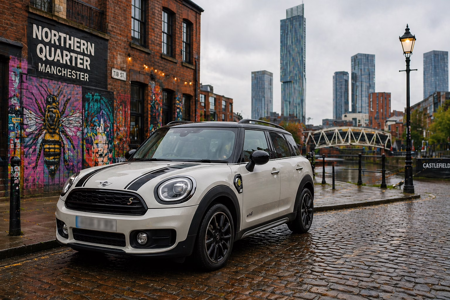 Mini car in Manchester city centre UK near skyline